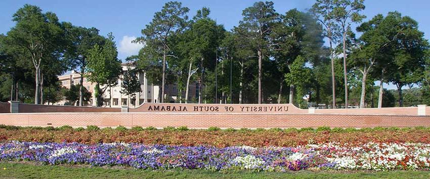 University of South Alabama street sign with flowers.